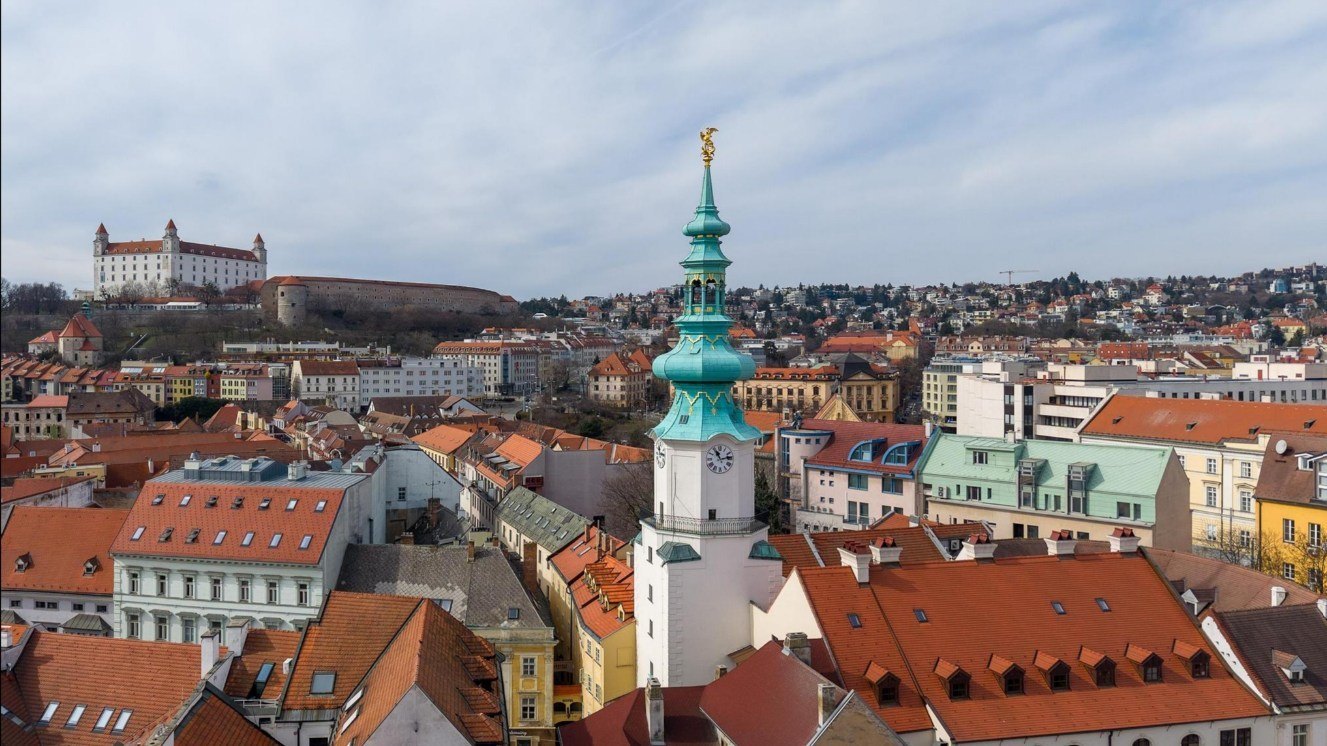 Aerial view over the red rooftops of Bratislava Old Town with the castle and St Michael's tower